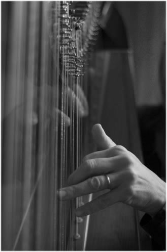 Photo of Loretta playing the harp